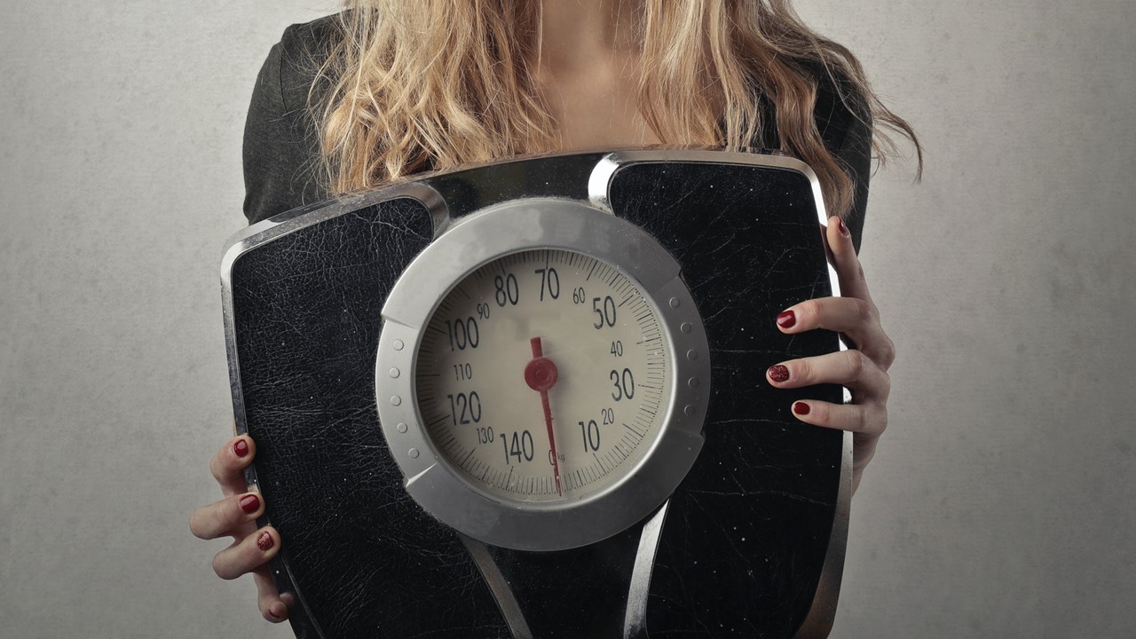 woman holding scale