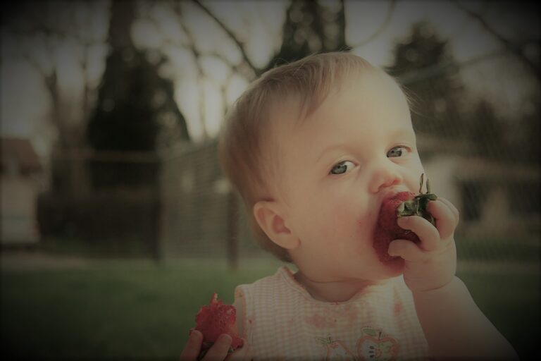 baby eating strawberry